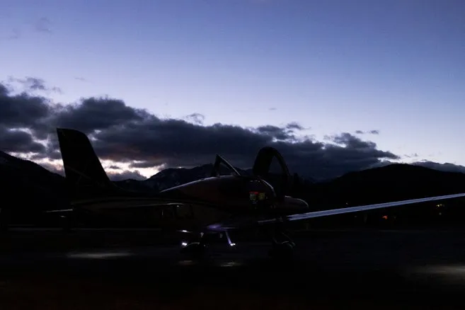 Aircraft wing against a dusk sky during evening operations