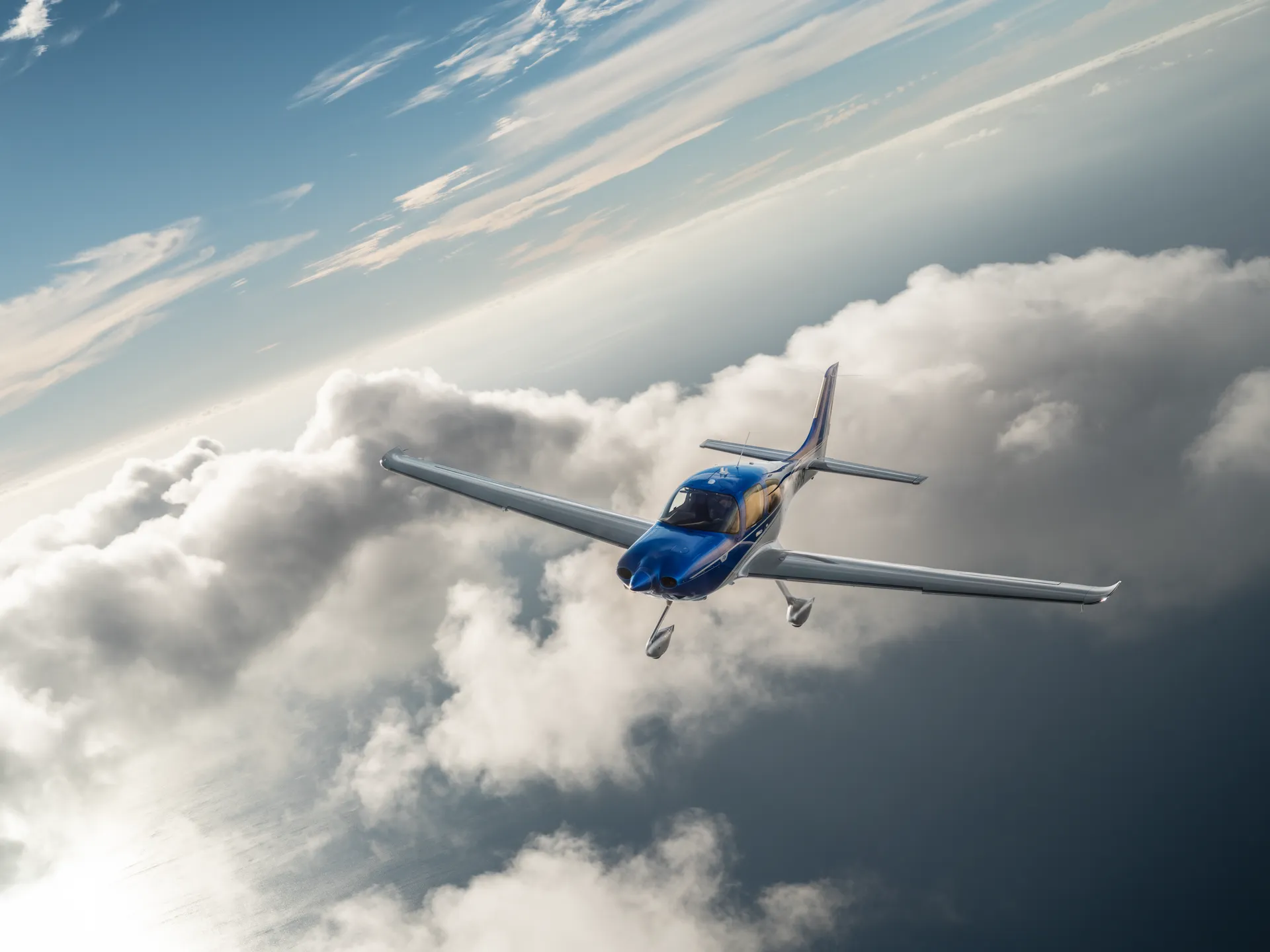 Cirrus SR22 G7+ in flight above the clouds at golden hour